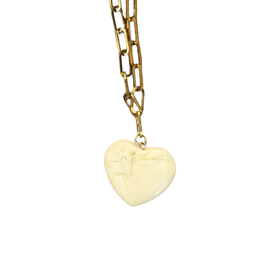 Gold chain necklace with a heart-shaped pendant on a white background