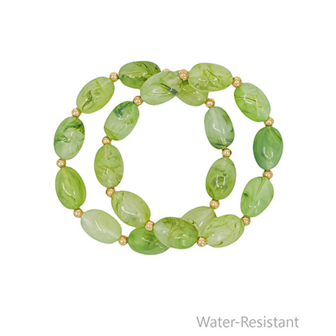 Green beaded bracelet on a white background with 'Water-Resistant' text.