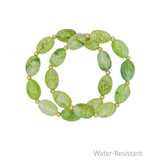 Green beaded bracelet on a white background with 'Water-Resistant' text.