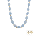 Necklace with blue beads and gold accents on a white background