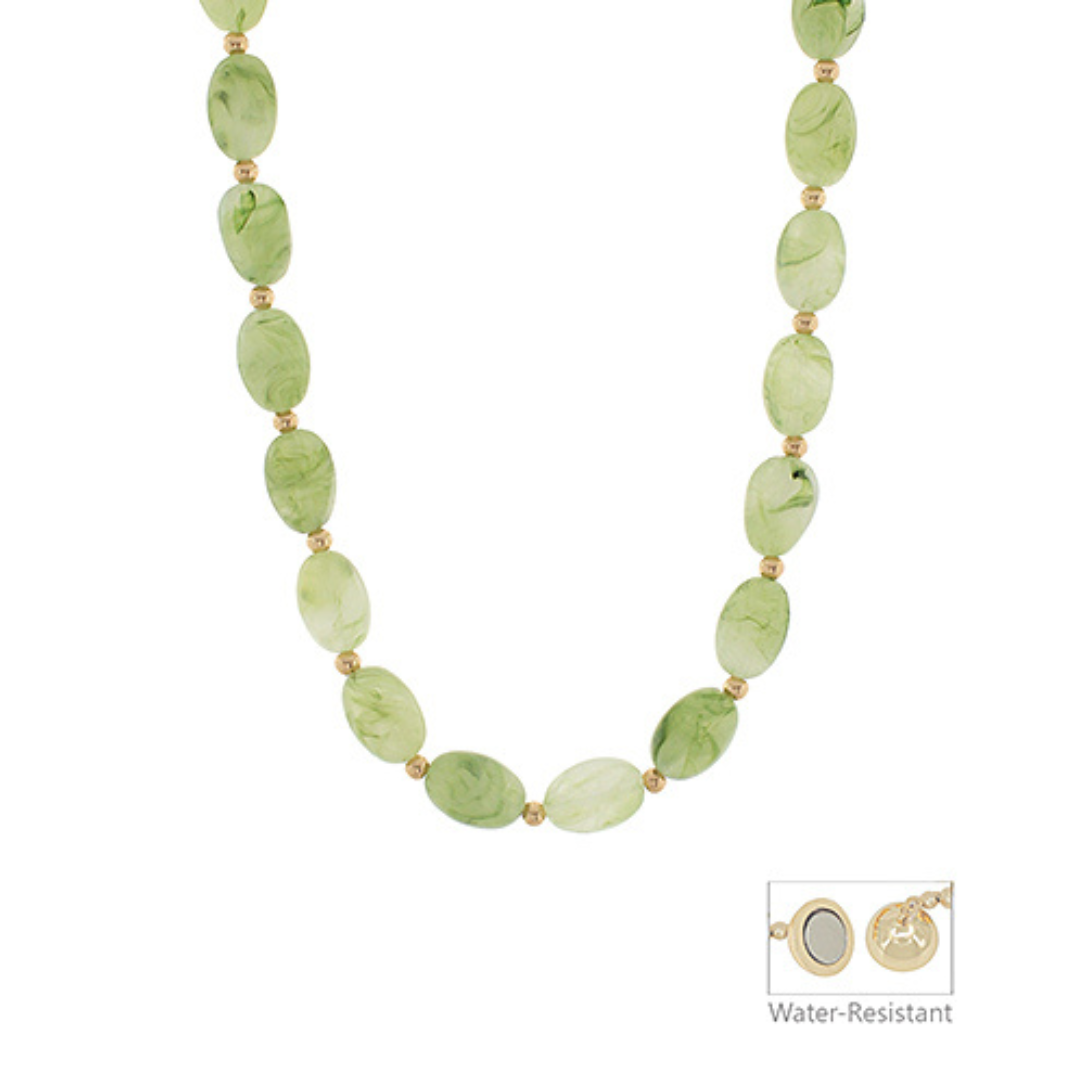 Necklace with green beads on a white background