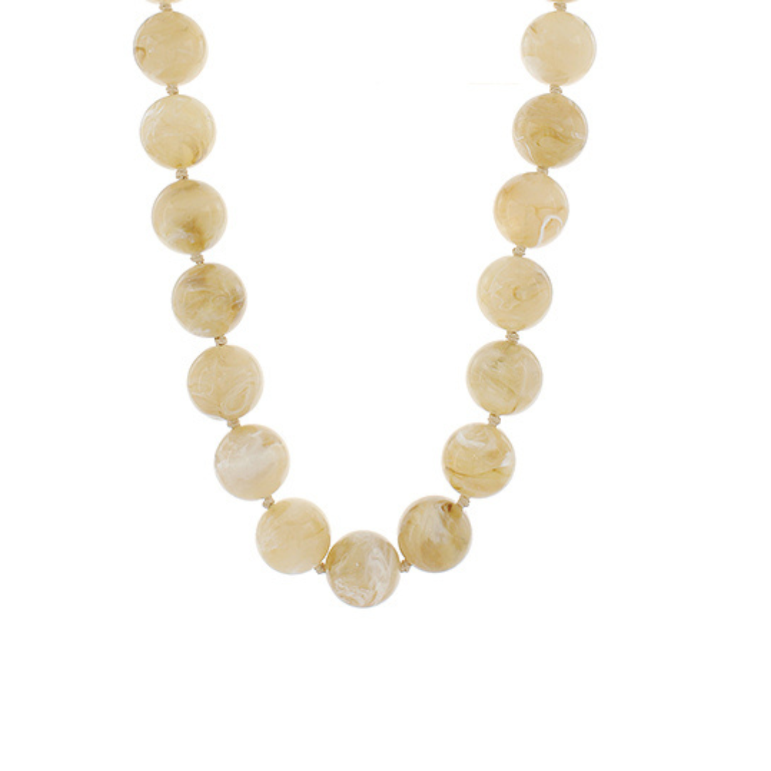 Beige beaded necklace on a white background