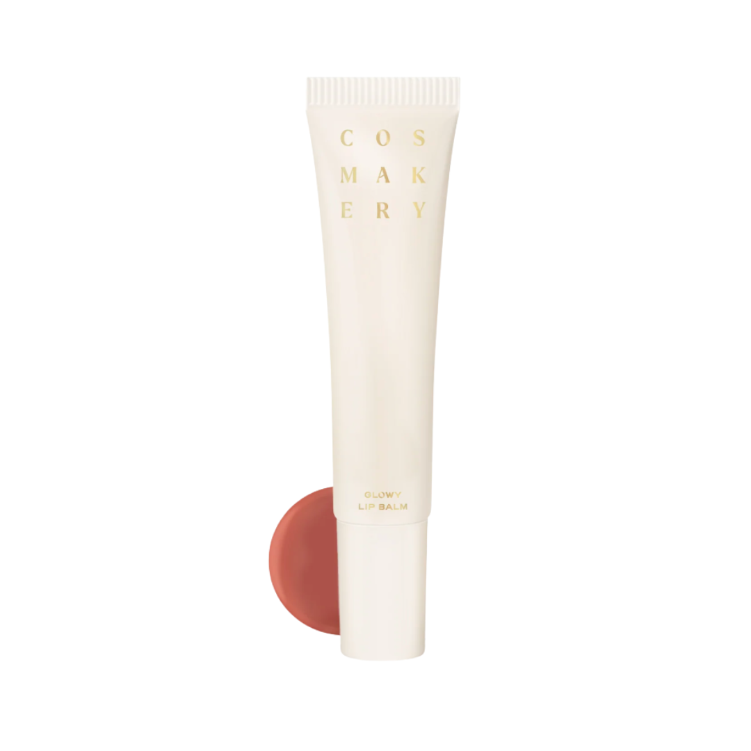 Cosmetics tube with a swatch of coral color on a white background