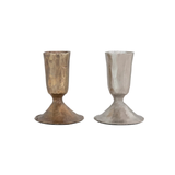 Two metallic candle holders, one gold and one silver, on a white background.