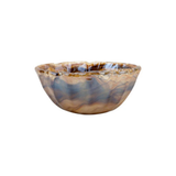 Decorative glass bowl with marbled pattern on a white background
