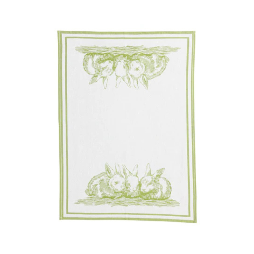White towel with green floral design on a white background