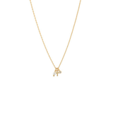 Delicate gold charm necklace with small charms including a mini cross, photographed on a white background.