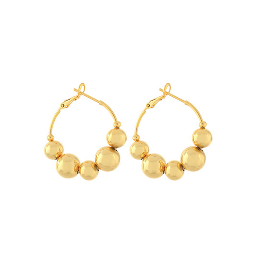 Gold hoop earrings featuring graduated multi-sized ball details along the front, photographed on a white background.