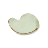 Heart-shaped ceramic dish with gold rim on a white background