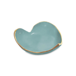 Teal heart-shaped dish with gold rim on a white background