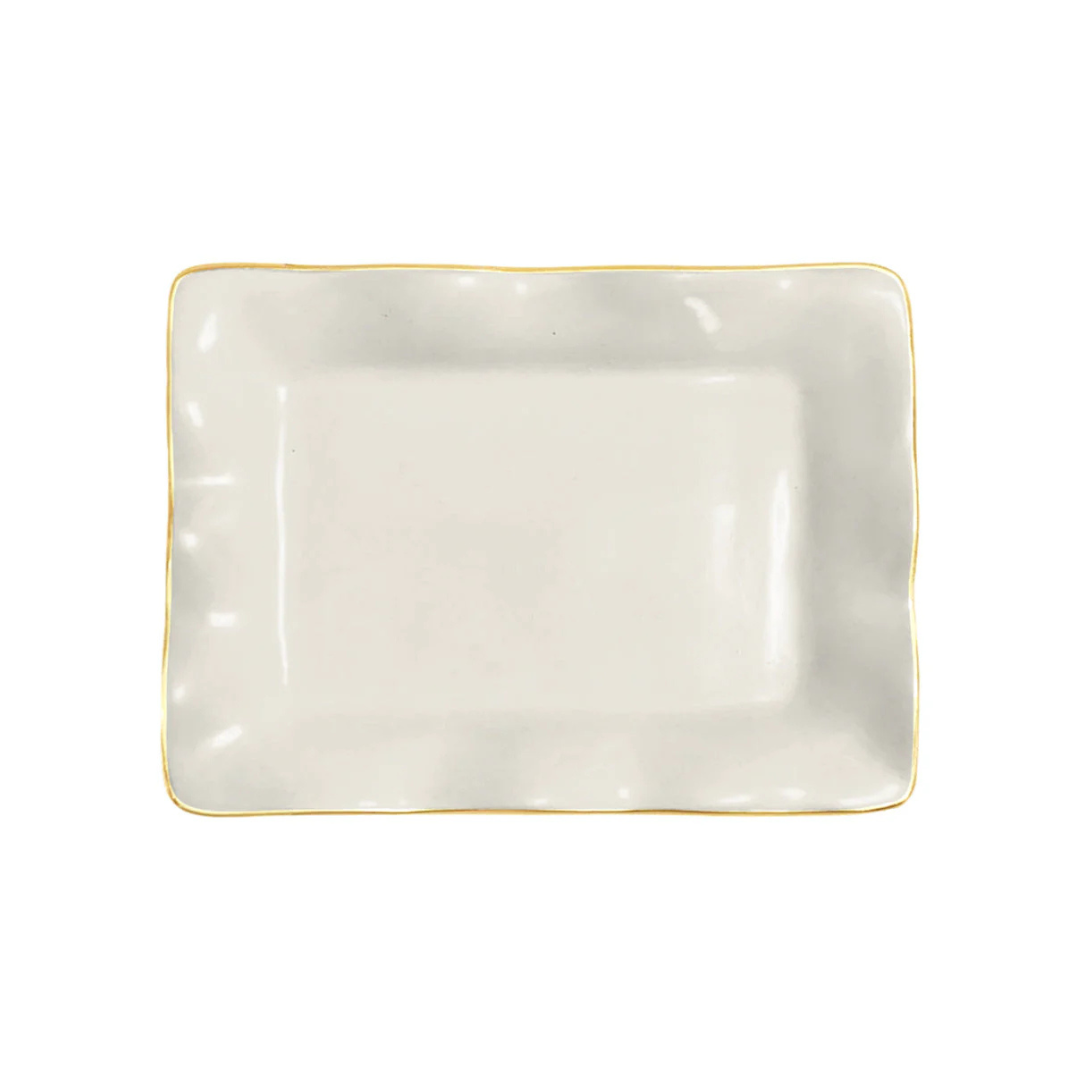 Rectangular white plate with gold rim on a white background