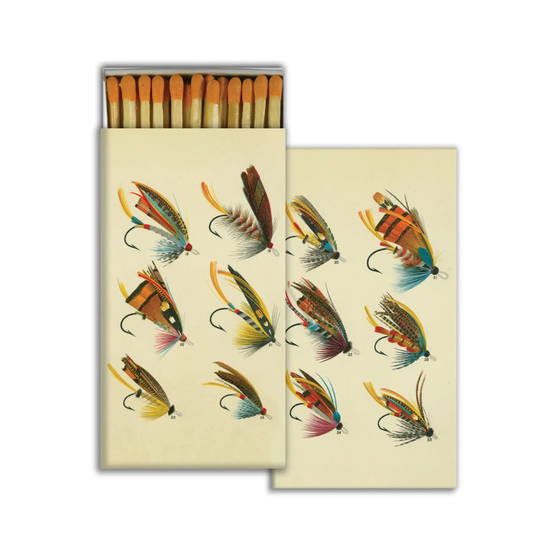 Matchbox with illustrations of fishing lures on a beige background