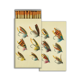Matchbox with illustrations of fishing lures on a beige background