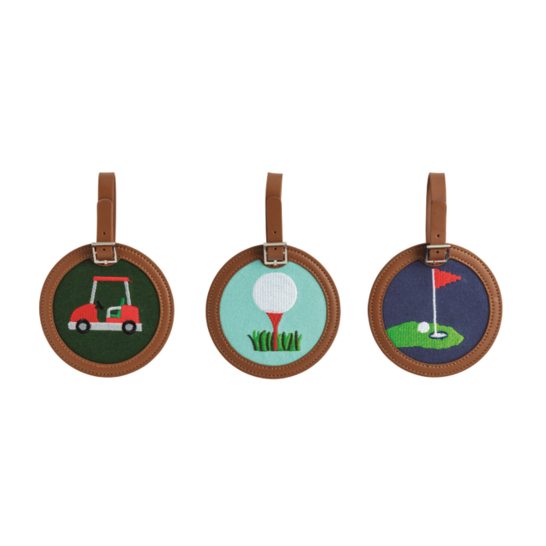 Three round embroidered tags with golf-themed designs on a white background