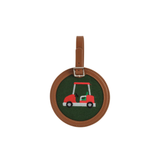 Round golf bag tag with a red golf cart design on a green background