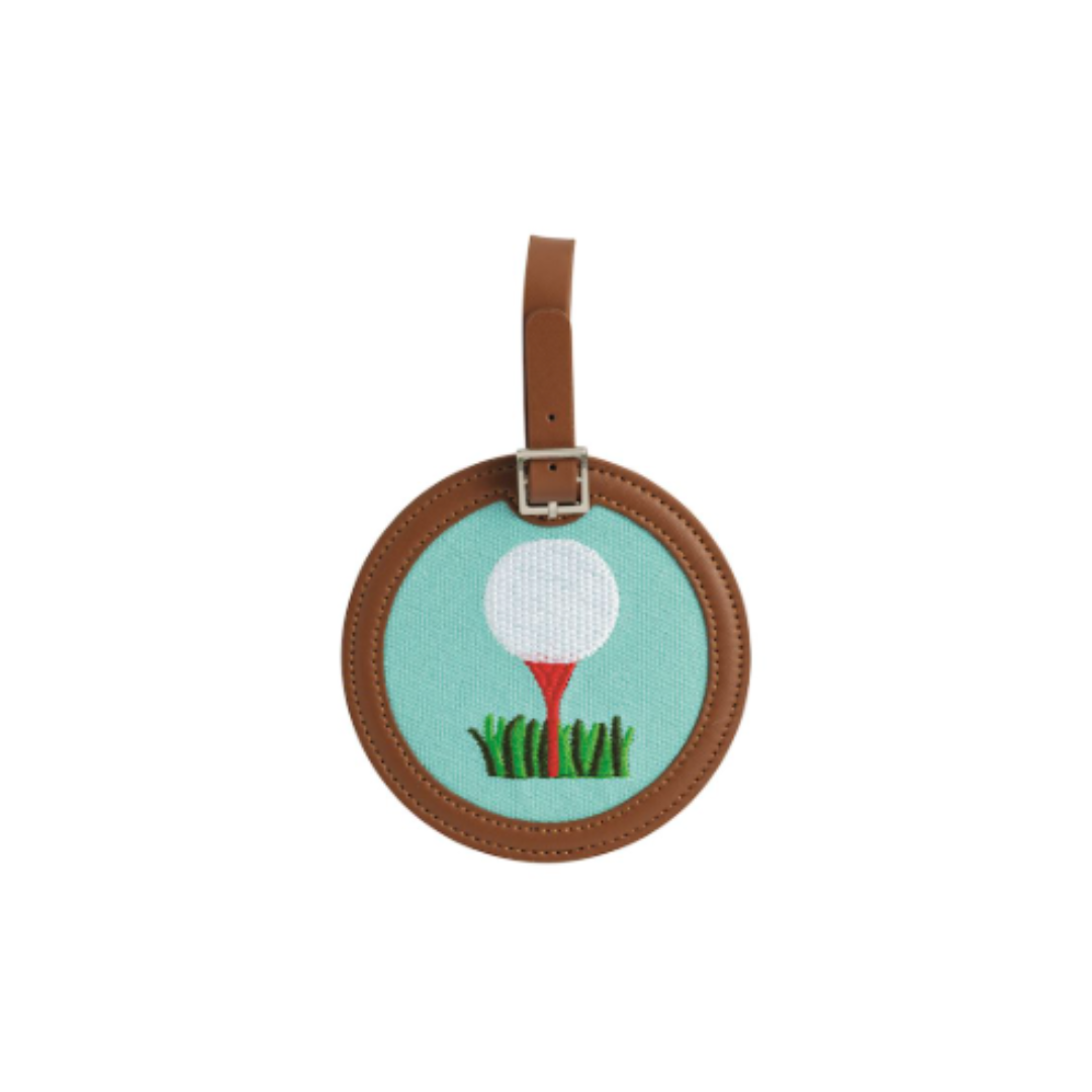 Round embroidered bag tag with golf ball and tee design on a white background