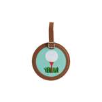 Round embroidered bag tag with golf ball and tee design on a white background
