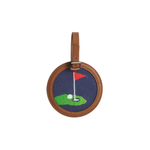 Round embroidered golf bag tag with golf design on a white background