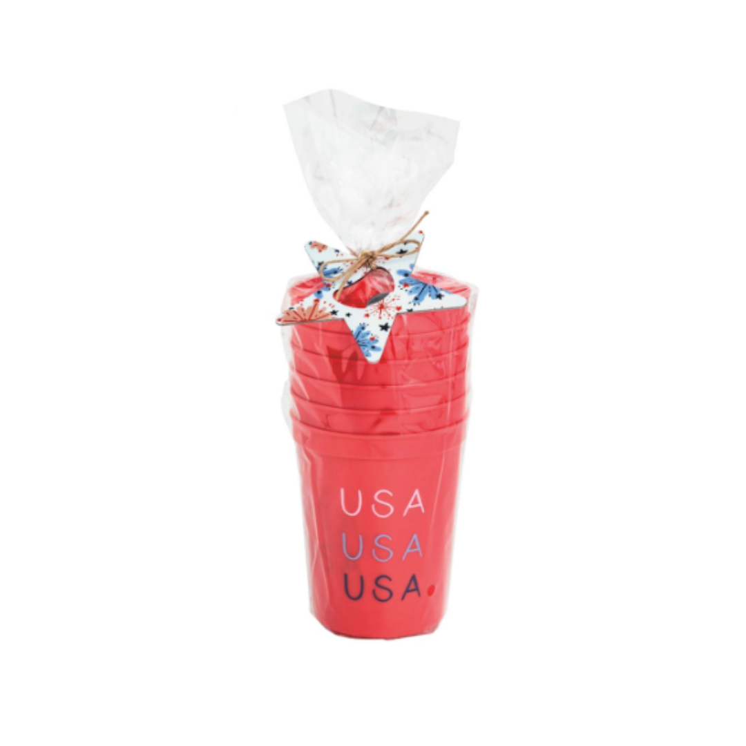 Set of red cups with 'USA' text, tied with a decorative bow on a white background