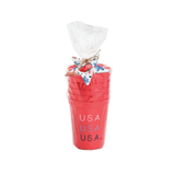 Set of red cups with 'USA' text, tied with a decorative bow on a white background
