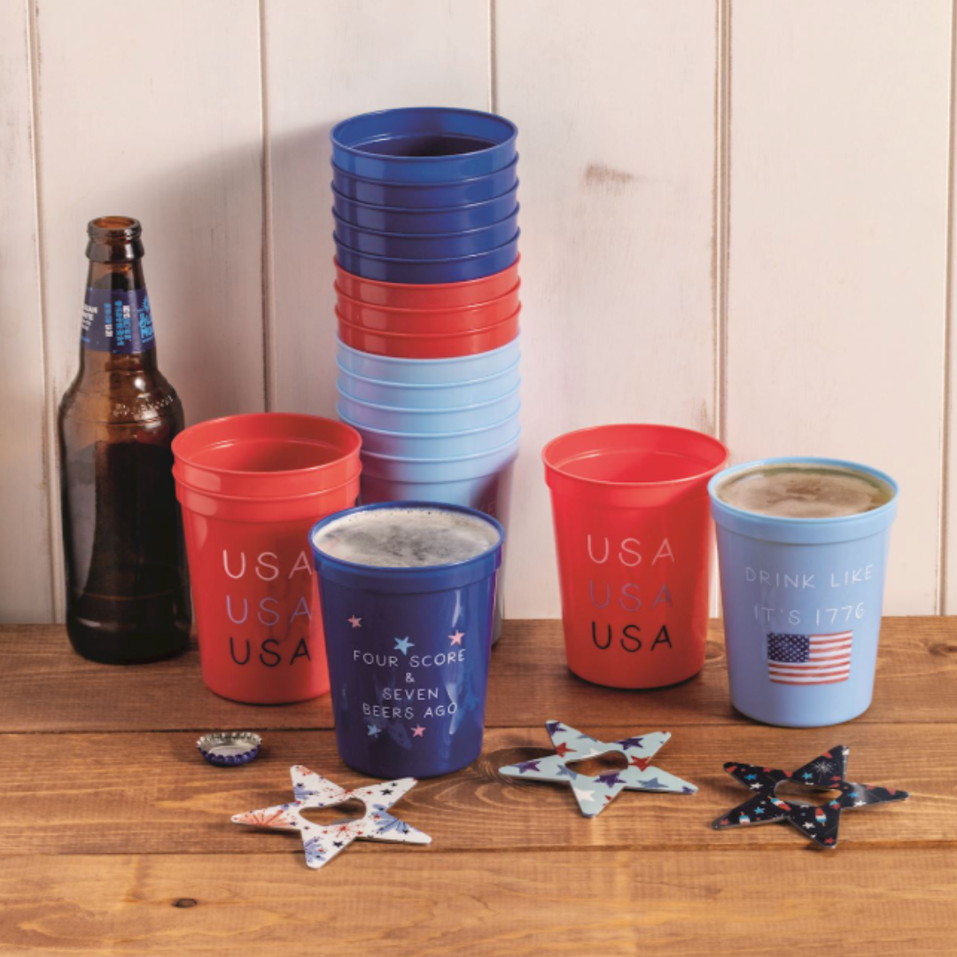 Stacked plastic cups in red, blue, and pink with 'USA' text on a wooden surface.