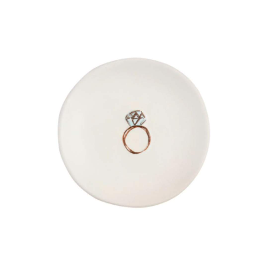 White ceramic ring dish with a rose gold ring design on a white background