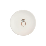 White ceramic ring dish with a rose gold ring design on a white background