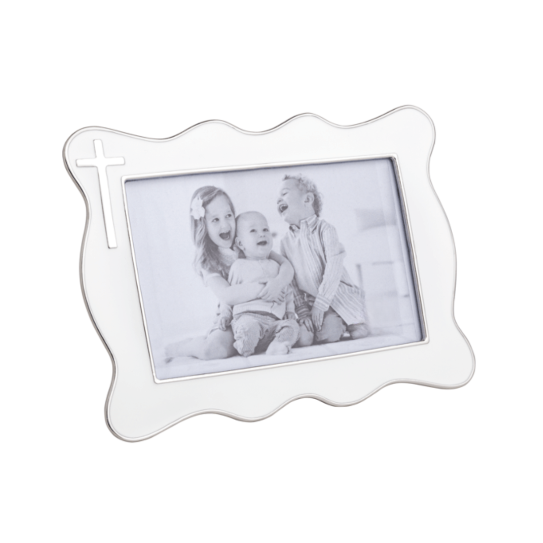 White decorative photo frame with a black and white photo of three children inside.