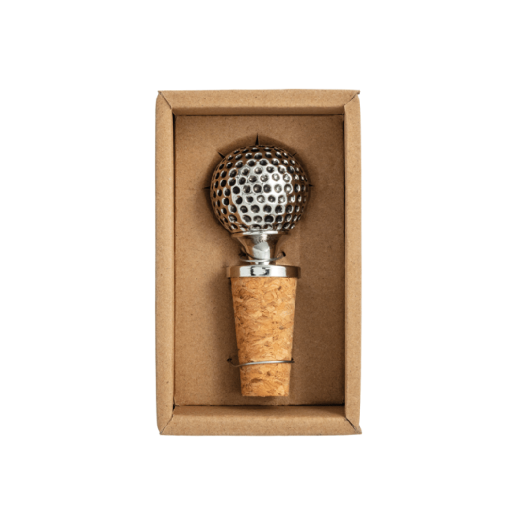 Golf ball-shaped bottle stopper with cork base in a cardboard box on a white background