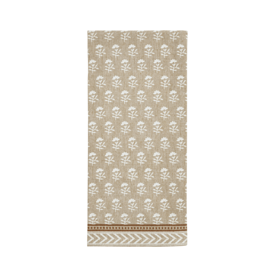 Beige towel with white floral pattern on a white background