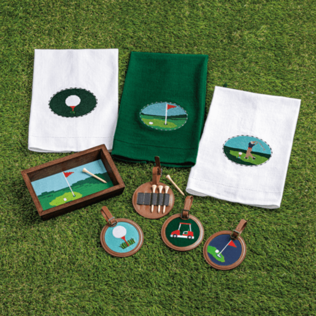 Golf-themed kitchen towels and decorative items on a grassy background
