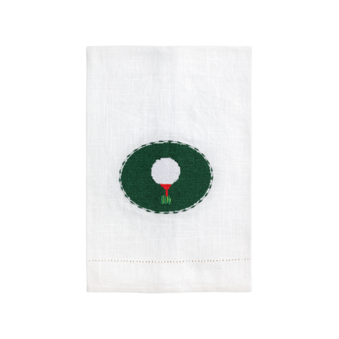 White towel with a golf ball design in the center on a white background