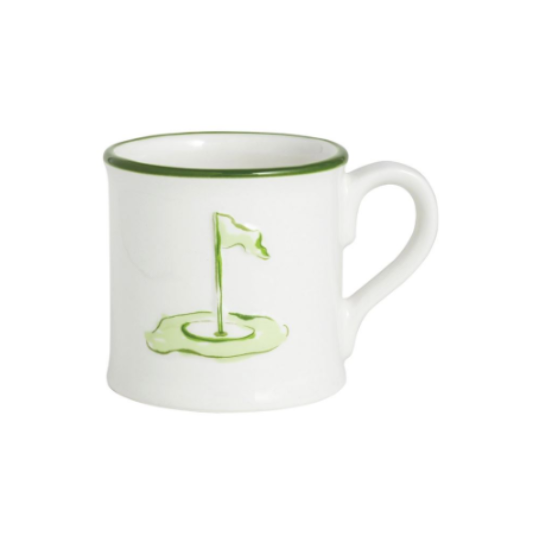 White mug with green rim and handle, featuring a golf flag design on a white background