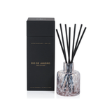 Aromatherapy diffuser with black sticks and a black box labeled 'Rio de Janeiro' on a white background.