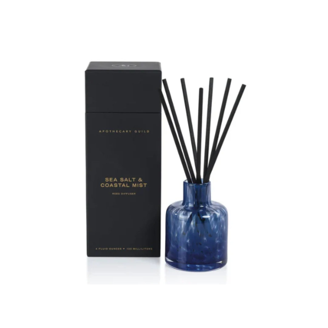 Navy diffuser bottle with black sticks and packaging on a white background