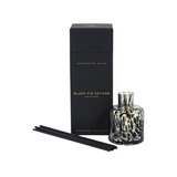 Aromatherapy diffuser set with black box, bottle, and sticks on a white background