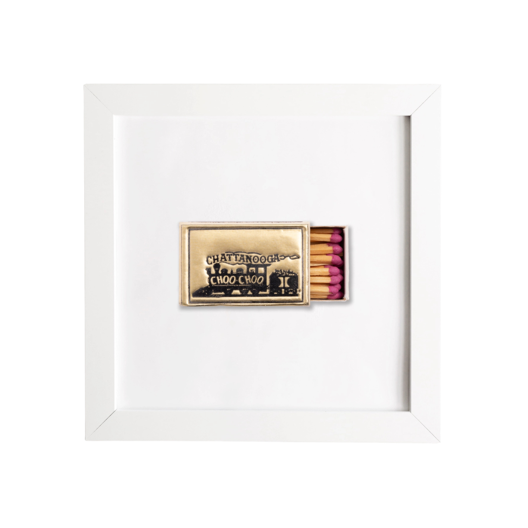 Matchbox with pink matches inside a white frame