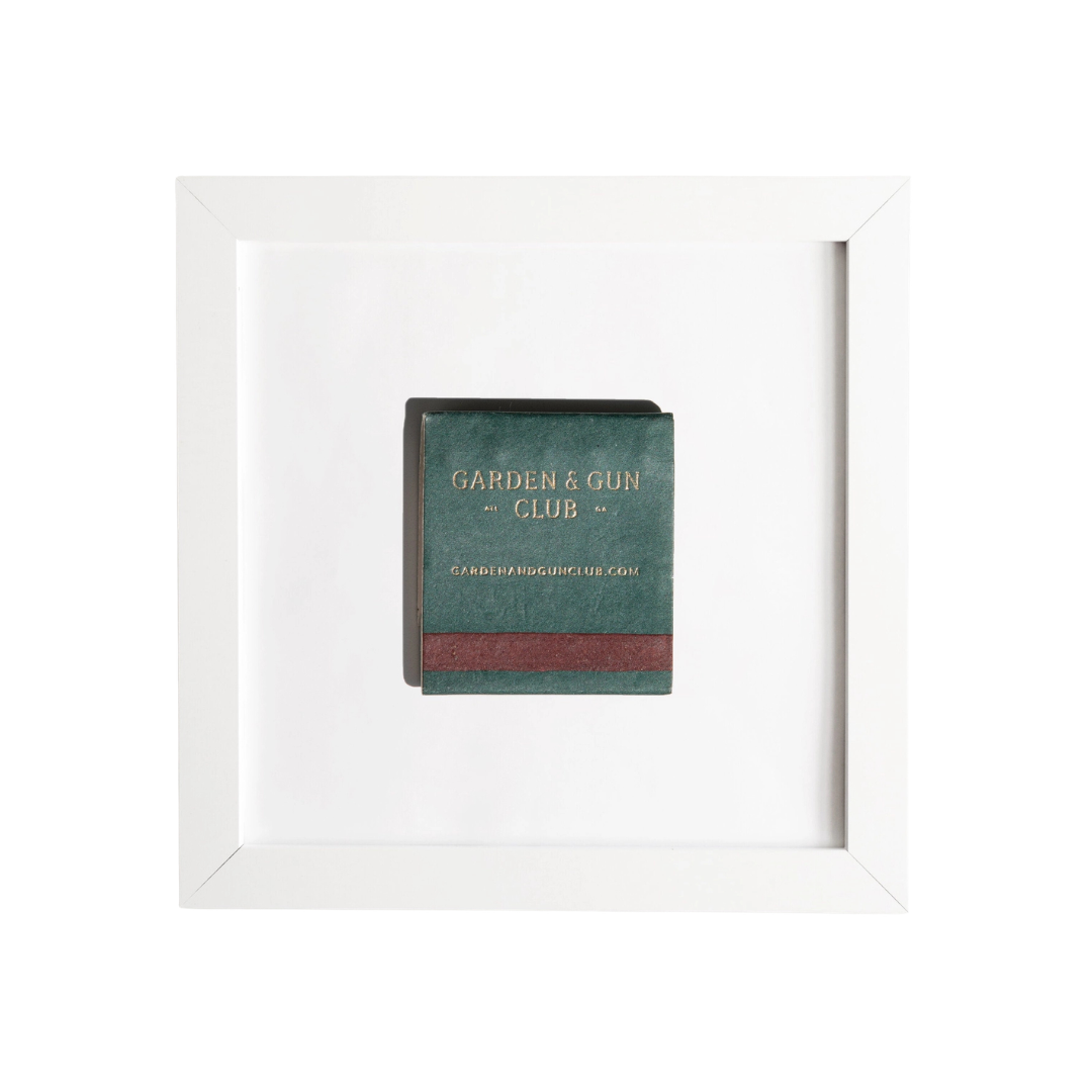 Framed print of 'Garden & Gun Club' matches with white frame on white background