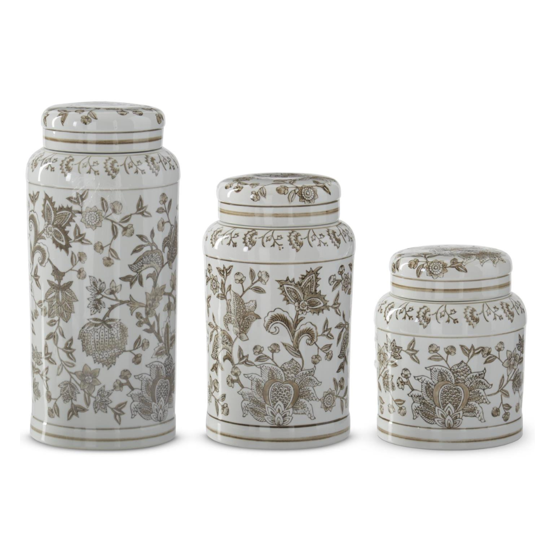 Three ceramic jars with floral patterns on a white background