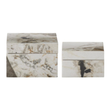 Two marble-patterned boxes on a white background