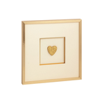 Framed artwork with a gold heart on a white background