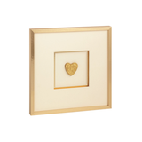 Framed artwork with a gold heart on a white background