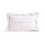 White pillow with embroidered green text on a white background