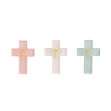 Three cross-shaped resin cross in pink, white, and light blue on a white background