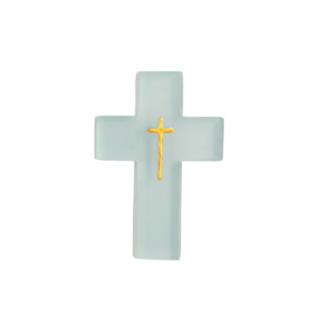 Cross-shaped resin cross with a gold center on a light blue background
