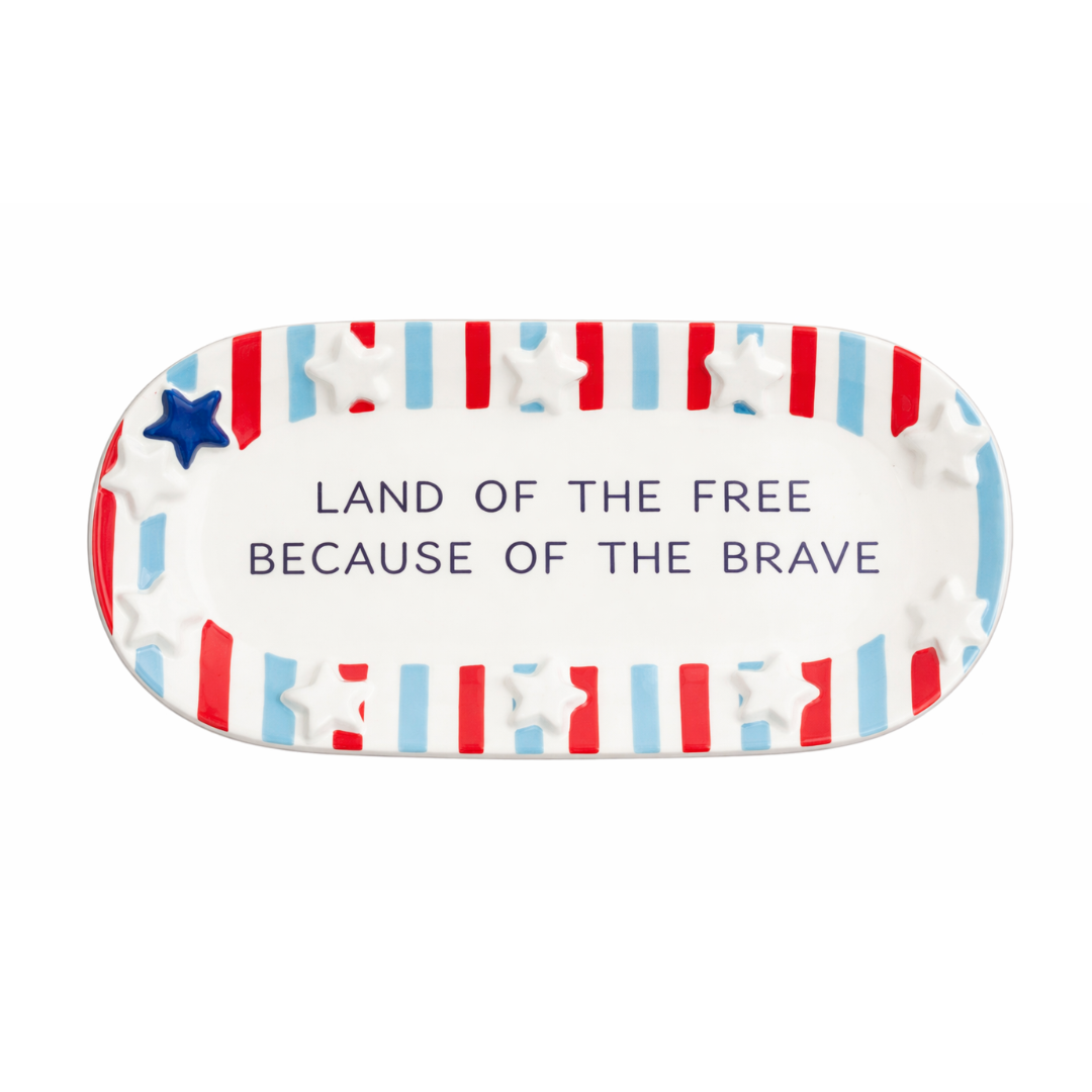Decorative plate with American flag design and text 'Land of the Free Because of the Brave' on a white background.