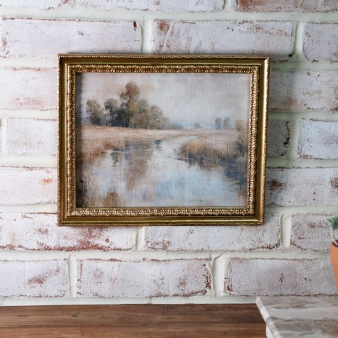 Framed painting on a textured brick wall