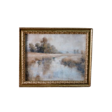 Framed painting of a landscape with trees and water on a white background
