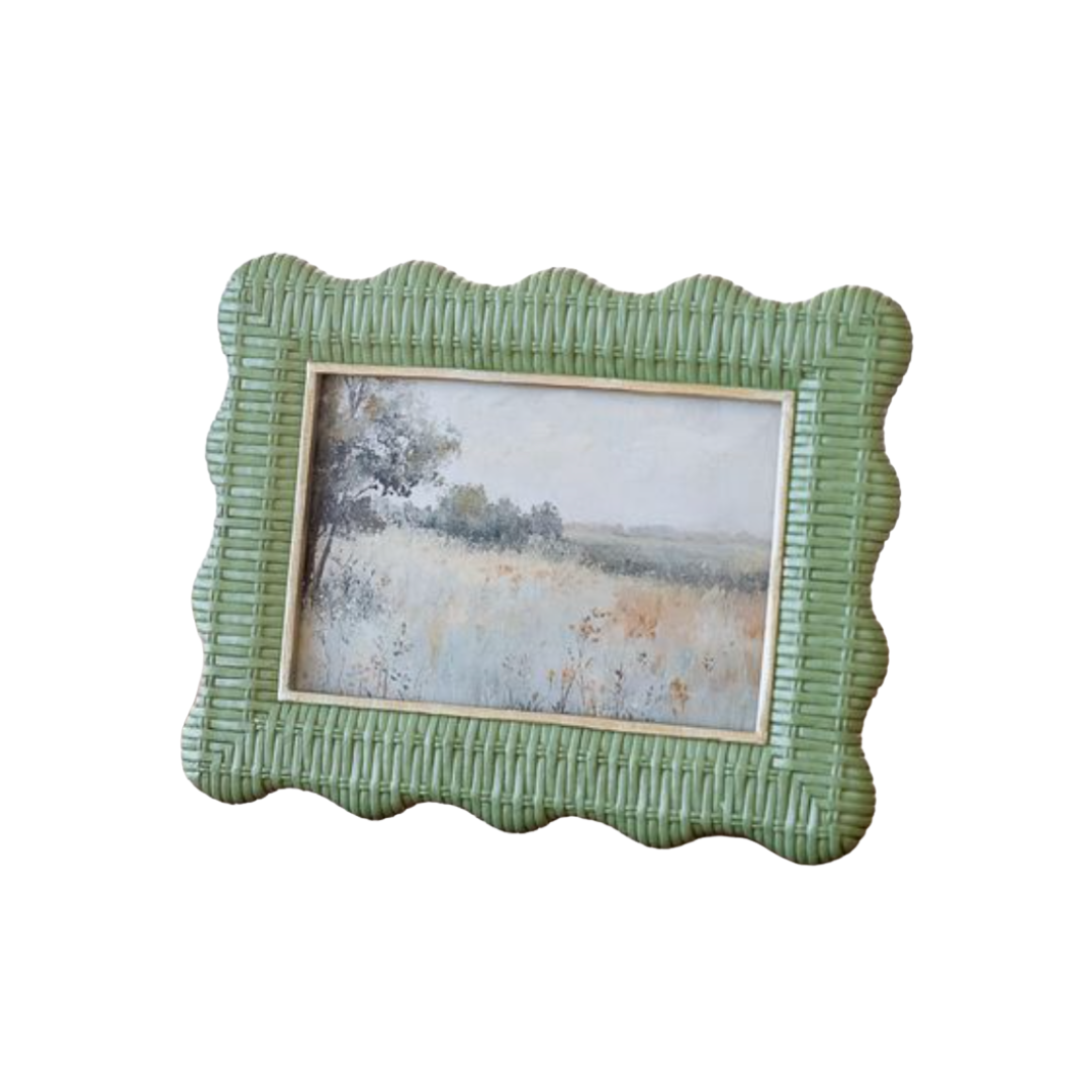 Green textured picture frame with a landscape painting inside on a white background