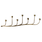 Brass candle holder with seven candle holders on a white background